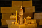 Witch, broom and witch hat shaped beeswax candles on beeswax bars with pumpkin beeswax candles