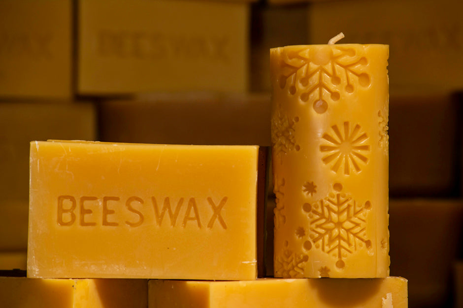 beeswax pillar candle with embossed snowflake designs on beeswax bars